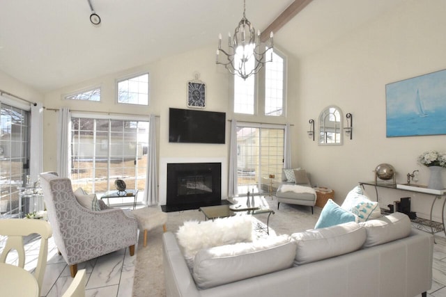 living room featuring an inviting chandelier, high vaulted ceiling, and a healthy amount of sunlight