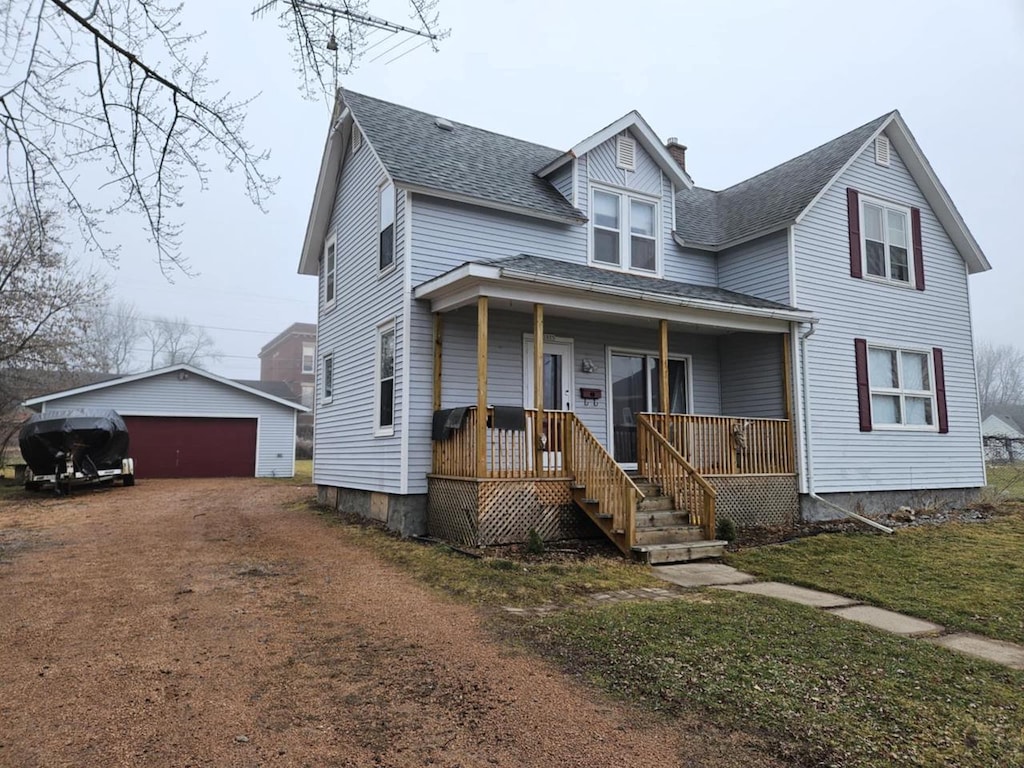 view of front of home featuring covered porch, a garage, and an outdoor structure