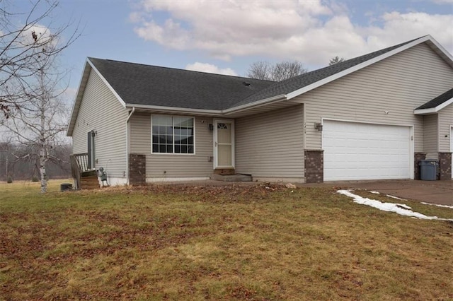 ranch-style house featuring a garage and a front yard