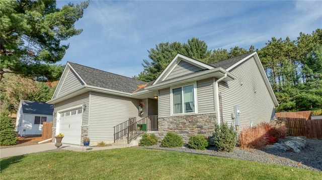 view of front of home with a front yard and a garage