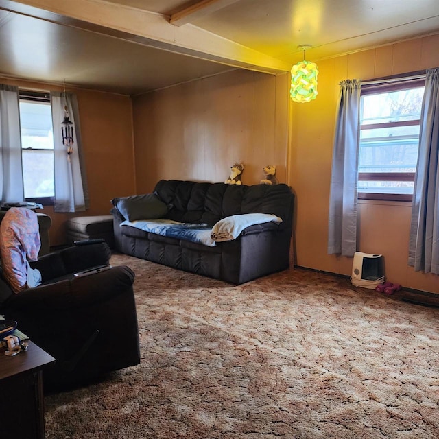 living room with beamed ceiling and carpet