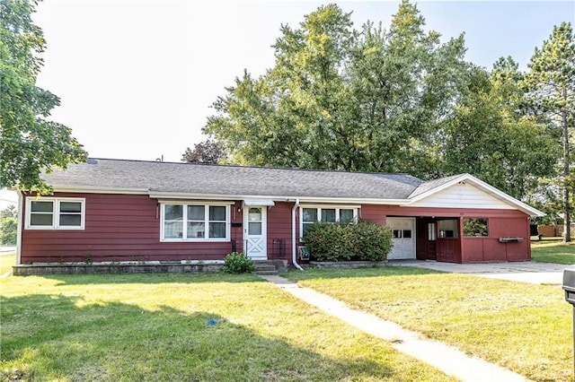 ranch-style home with a carport and a front lawn