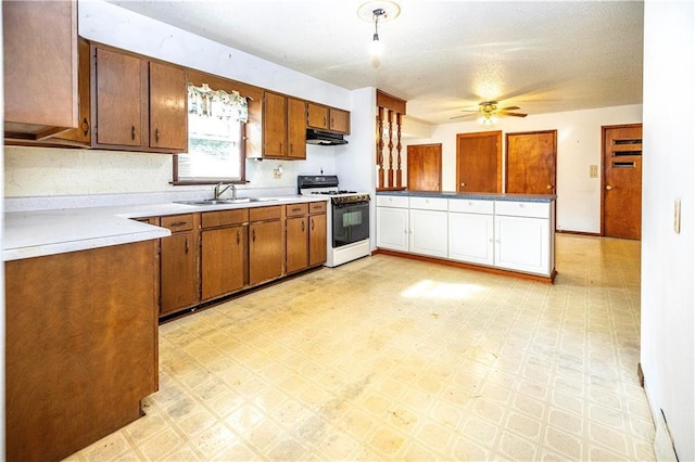 kitchen with white range with gas cooktop, ceiling fan, sink, and range hood