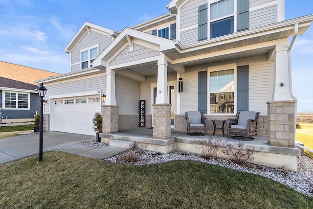 craftsman inspired home featuring a porch, a garage, and a front lawn