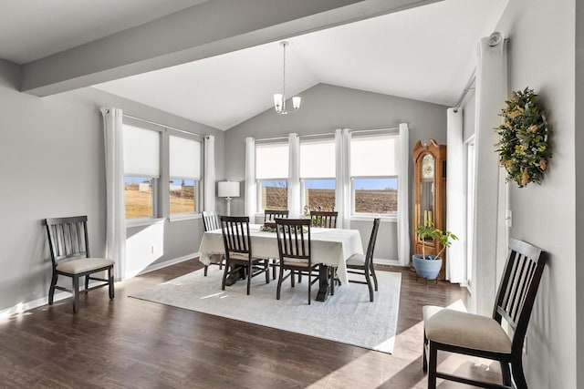 dining space with dark hardwood / wood-style flooring, plenty of natural light, lofted ceiling, and a notable chandelier