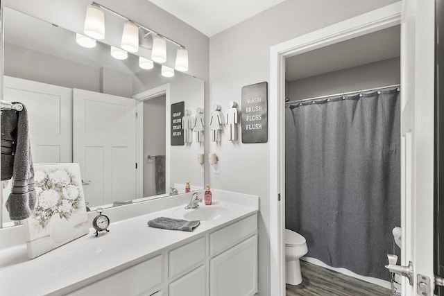 bathroom featuring hardwood / wood-style floors, vanity, and toilet