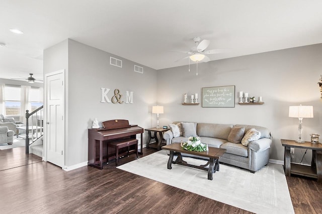 living room with ceiling fan and dark hardwood / wood-style floors