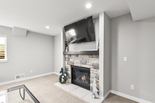 carpeted living room with a fireplace