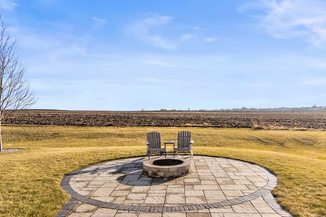 view of patio / terrace with a rural view and a fire pit