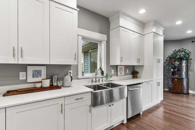 kitchen with light stone counters, stainless steel dishwasher, sink, dark hardwood / wood-style floors, and white cabinetry