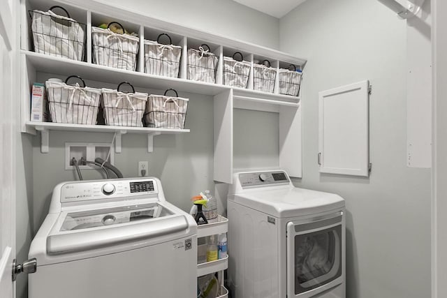 clothes washing area featuring washer and dryer