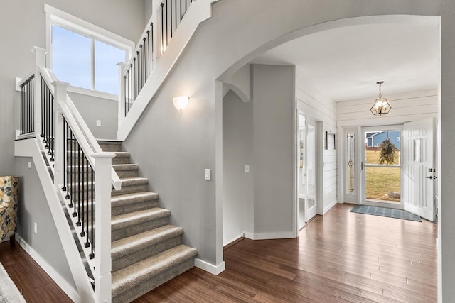 entrance foyer featuring dark wood-type flooring and a chandelier