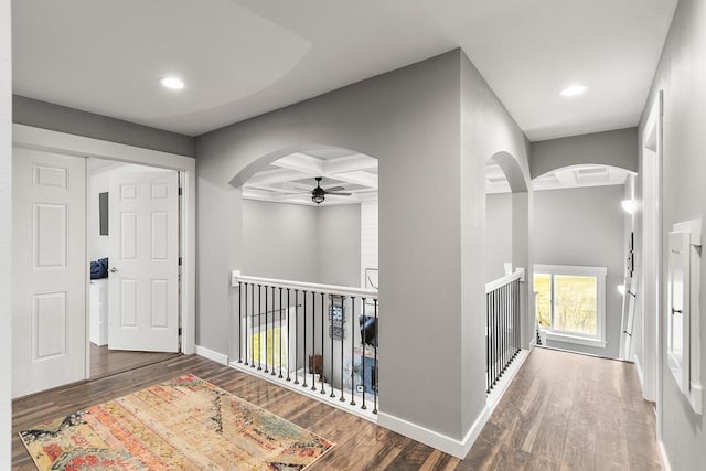 hall with beam ceiling, dark hardwood / wood-style floors, and coffered ceiling