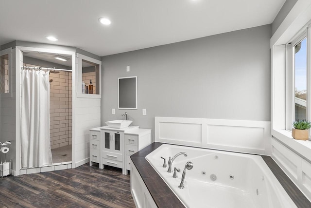 bathroom featuring hardwood / wood-style flooring, vanity, and independent shower and bath