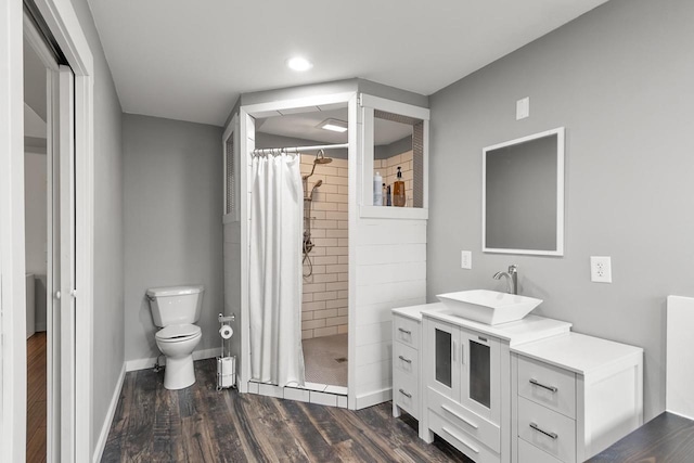 bathroom featuring vanity, curtained shower, toilet, and wood-type flooring