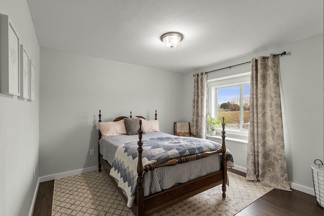 bedroom featuring a textured ceiling and light hardwood / wood-style floors