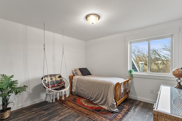 bedroom with dark hardwood / wood-style flooring