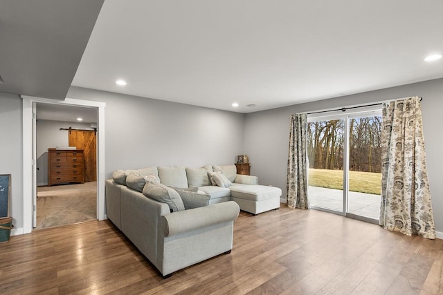 living room with hardwood / wood-style floors and a barn door