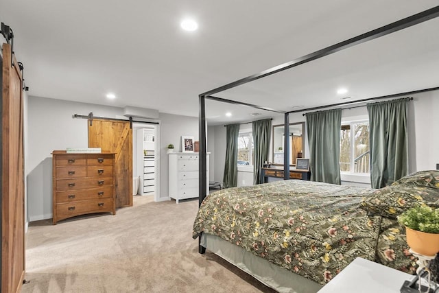 bedroom with light carpet, a barn door, and multiple windows