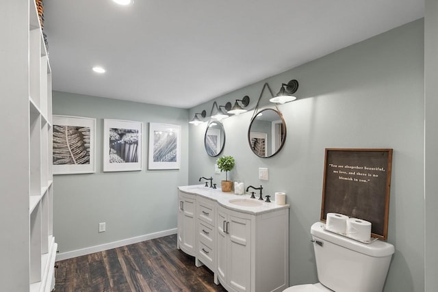 bathroom featuring vanity, hardwood / wood-style flooring, and toilet