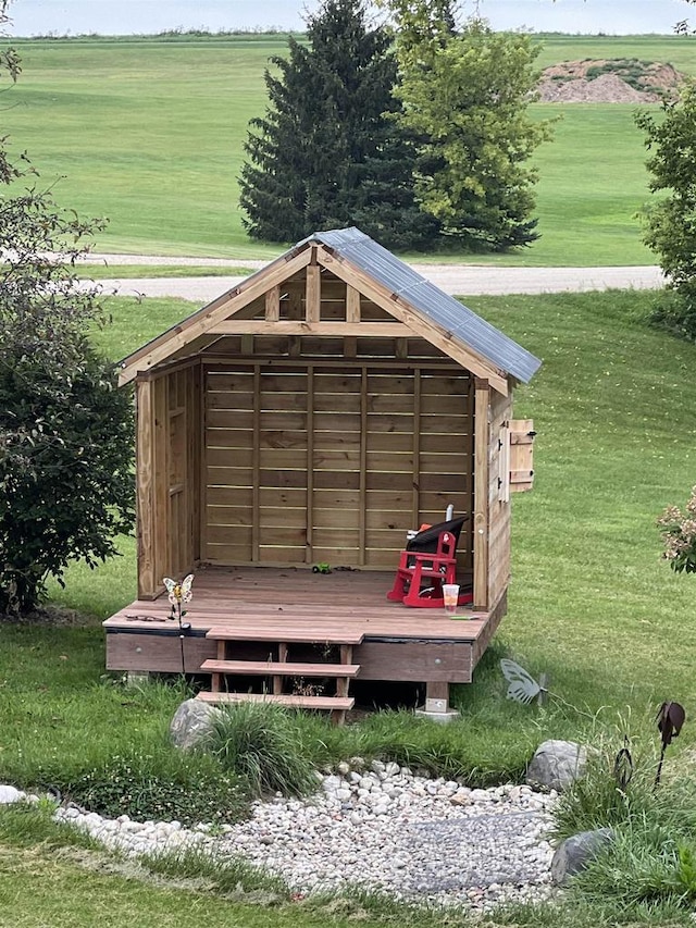 view of outbuilding with a yard and a rural view