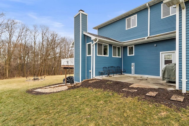 rear view of house featuring a yard and a patio