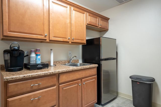 kitchen featuring stainless steel fridge and sink