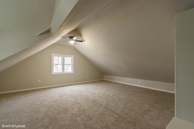 additional living space with carpet flooring, ceiling fan, and lofted ceiling