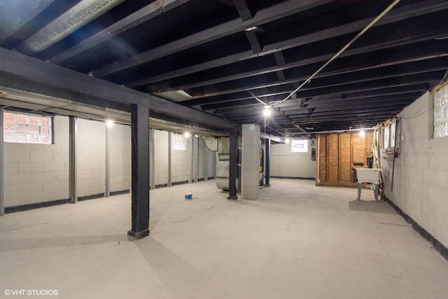 basement featuring heating unit and sink