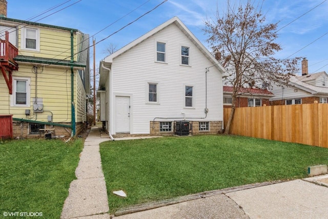 rear view of property featuring a yard