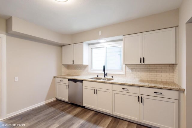 kitchen with sink, stainless steel dishwasher, light stone counters, dark hardwood / wood-style flooring, and white cabinetry