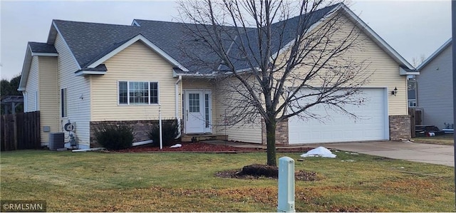 view of front facade with a front lawn, central AC unit, and a garage