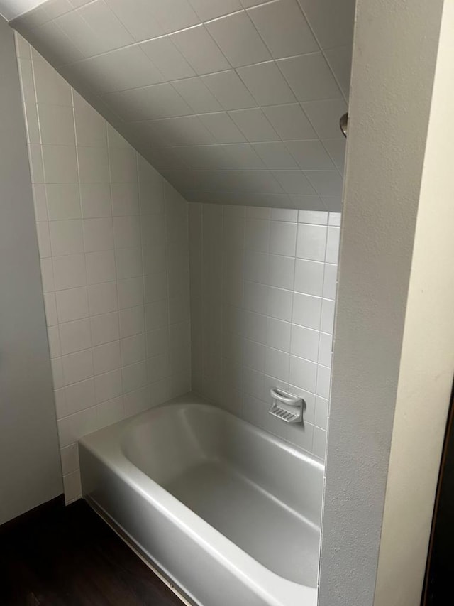 bathroom featuring vaulted ceiling and shower / bathtub combination