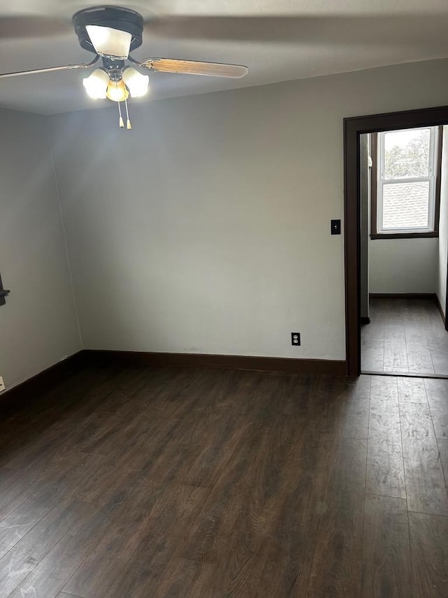 spare room with ceiling fan and dark hardwood / wood-style floors