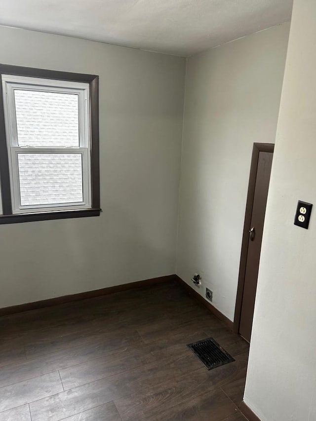 empty room with dark hardwood / wood-style floors