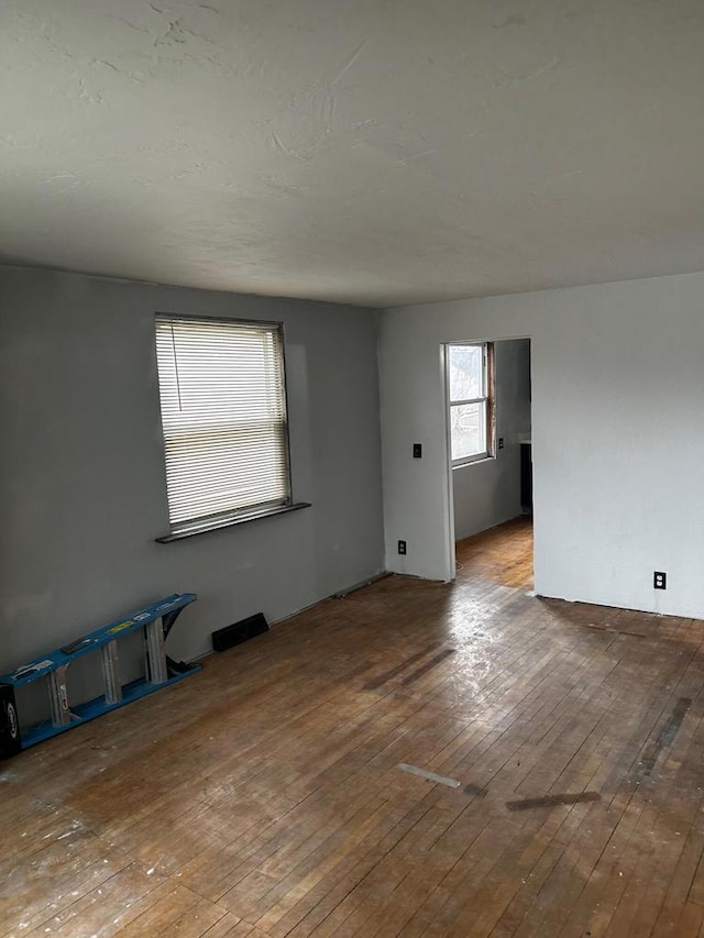 empty room with hardwood / wood-style floors