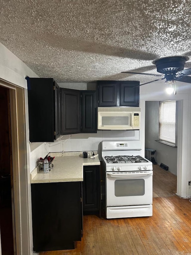 kitchen with ceiling fan, wood-type flooring, and white appliances