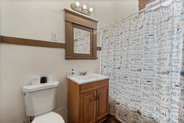 bathroom with vanity, toilet, and walk in shower