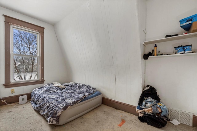 bedroom with light carpet and lofted ceiling