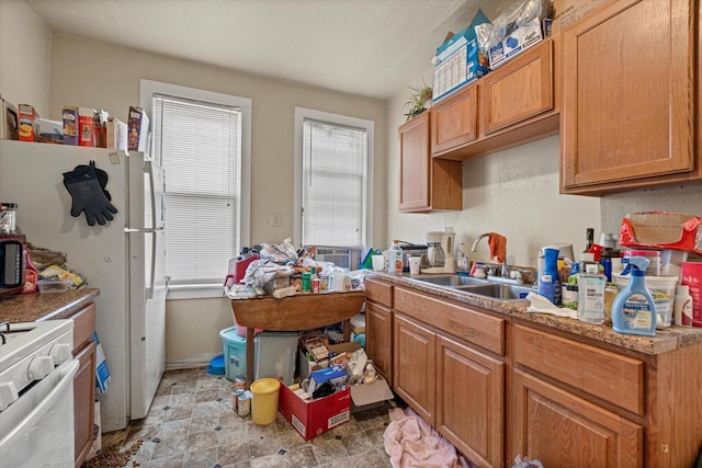 kitchen featuring sink, stove, and white refrigerator