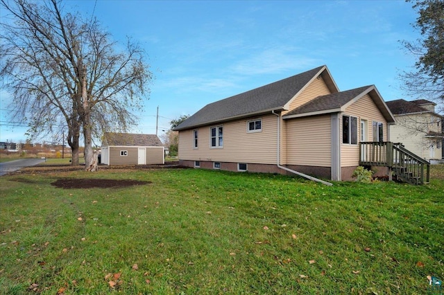 view of home's exterior with a yard and an outbuilding