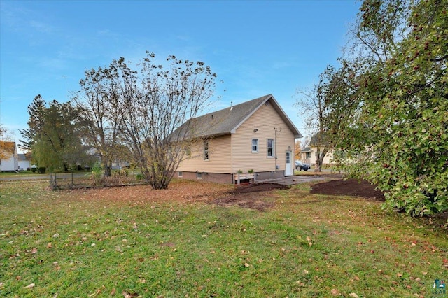 view of side of home featuring a lawn