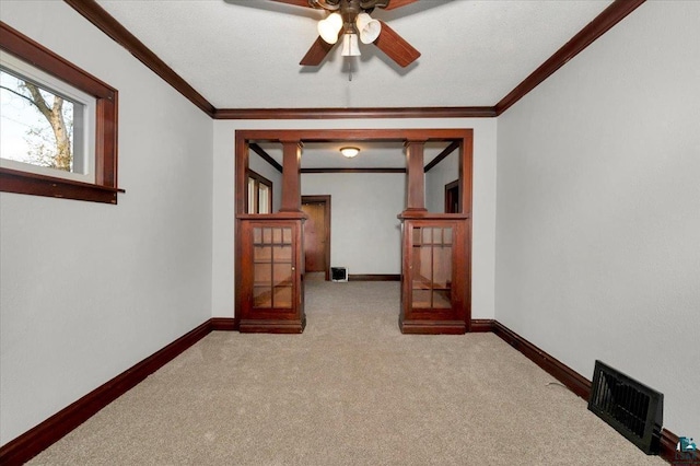 corridor featuring french doors, light colored carpet, and crown molding