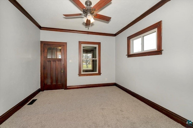 interior space featuring crown molding, carpet floors, and ceiling fan