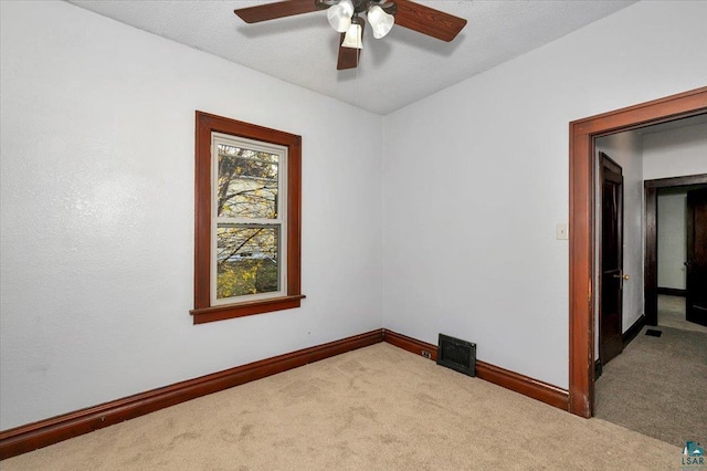 carpeted empty room featuring ceiling fan