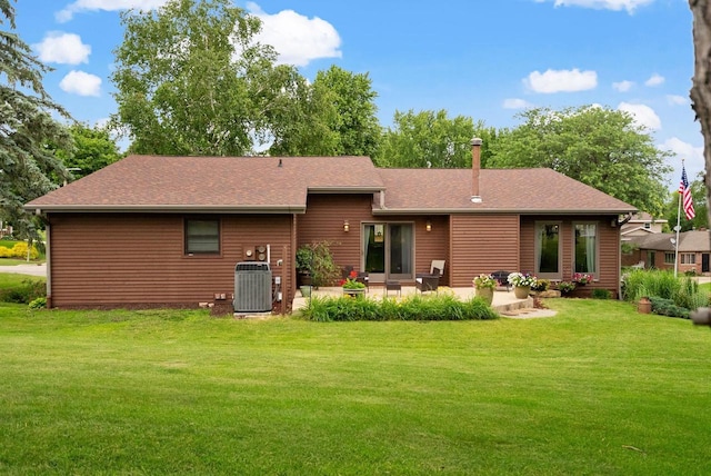 2022 27th St, Monroe, WI 53566 - rear view of house with a patio, cooling unit, a yard, and roof with shingles
