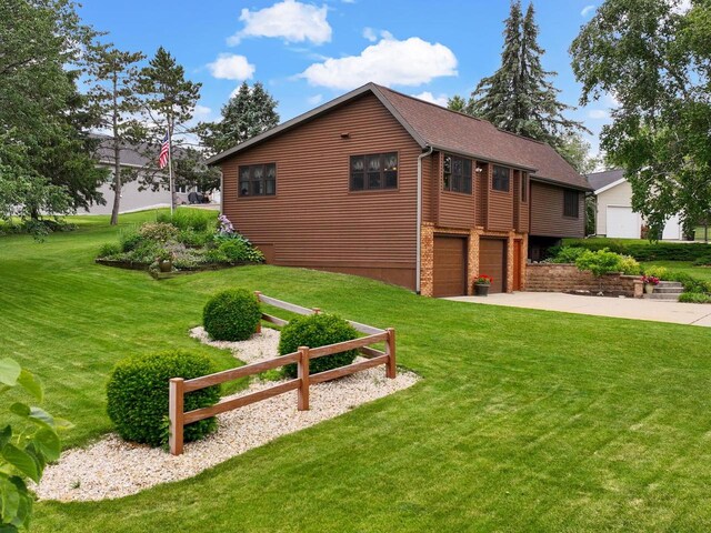 2022 27th St, Monroe, WI 53566 - view of home's exterior with an attached garage, concrete driveway, and a yard
