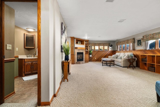 2022 27th St, Monroe, WI 53566 - living area featuring wooden walls, light colored carpet, and a tile fireplace