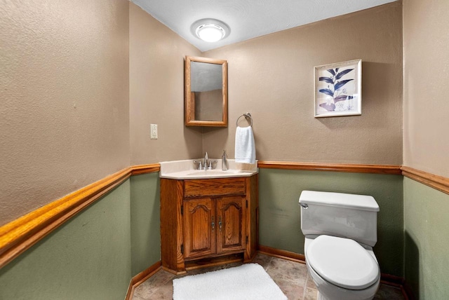 2022 27th St, Monroe, WI 53566 - half bath with vanity, toilet, and baseboards