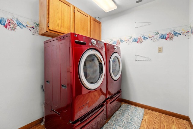 2022 27th St, Monroe, WI 53566 - laundry area with separate washer and dryer, cabinet space, and baseboards